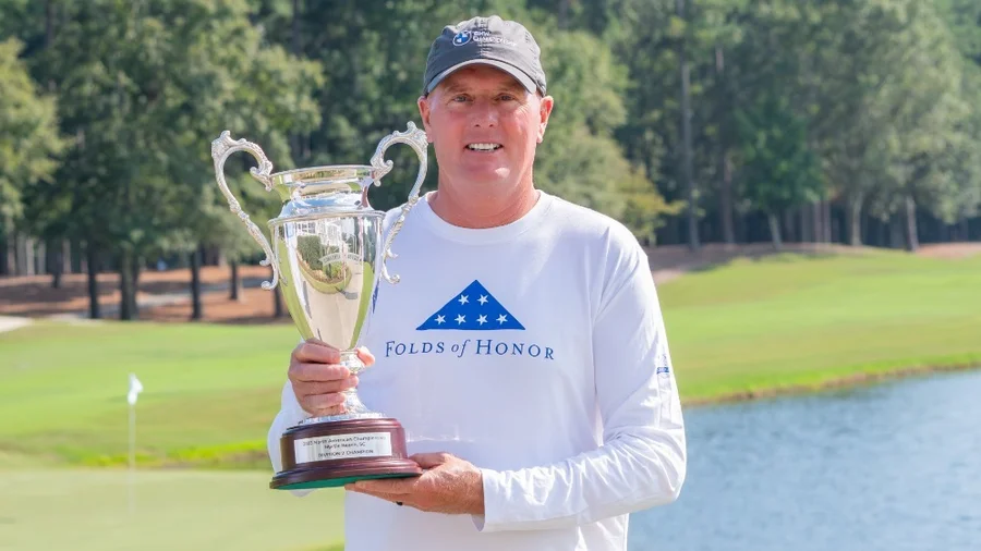 Amateur Players Tour champion holding a trophy